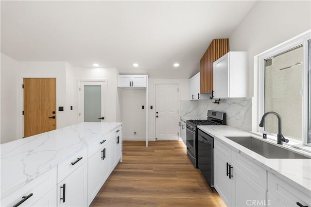 18718 Delight St, Canyon Country, CA 91351 - kitchen with stainless steel gas range, dishwashing machine, light stone countertops, white cabinets, and recessed lighting