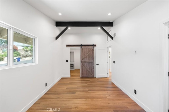 18718 Delight St, Canyon Country, CA 91351 - empty room featuring a barn door, light wood-style flooring, and recessed lighting