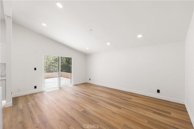 18718 Delight St, Canyon Country, CA 91351 - unfurnished living room with vaulted ceiling, light wood-style flooring, and recessed lighting