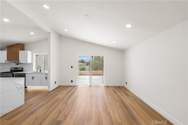 18718 Delight St, Canyon Country, CA 91351 - unfurnished living room with vaulted ceiling, light wood-style floors, and recessed lighting