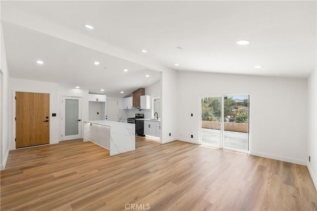 18718 Delight St, Canyon Country, CA 91351 - unfurnished living room featuring vaulted ceiling, light wood-type flooring, and recessed lighting