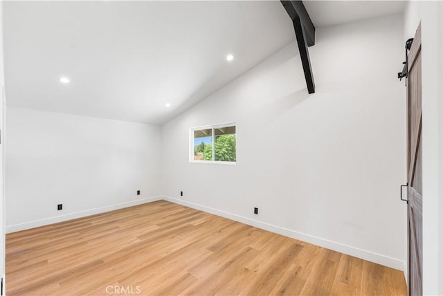 18718 Delight St, Canyon Country, CA 91351 - unfurnished room featuring a barn door, light wood finished floors, and recessed lighting