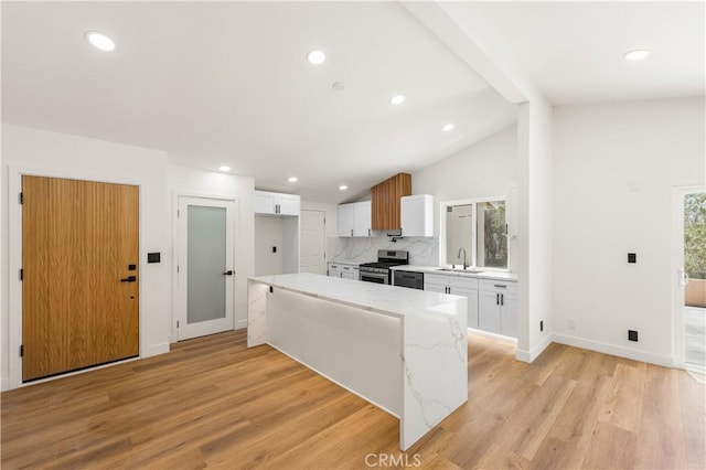 18718 Delight St, Canyon Country, CA 91351 - kitchen with appliances with stainless steel finishes, white cabinets, tasteful backsplash, light wood-style flooring, and recessed lighting