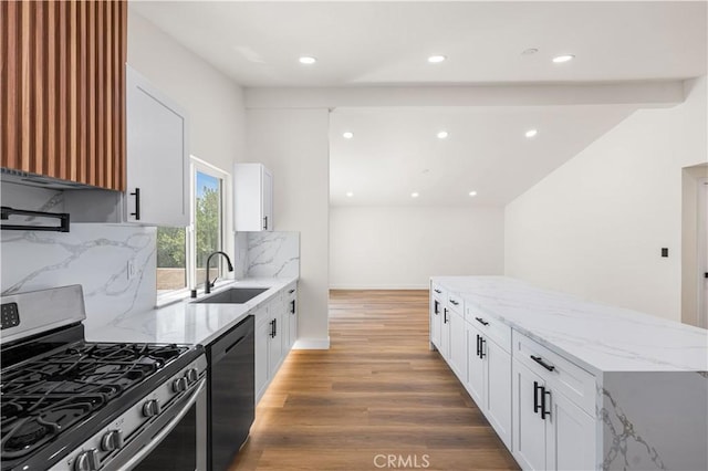 18718 Delight St, Canyon Country, CA 91351 - kitchen featuring gas range, black dishwasher, light wood-style floors, light stone counters, and decorative backsplash