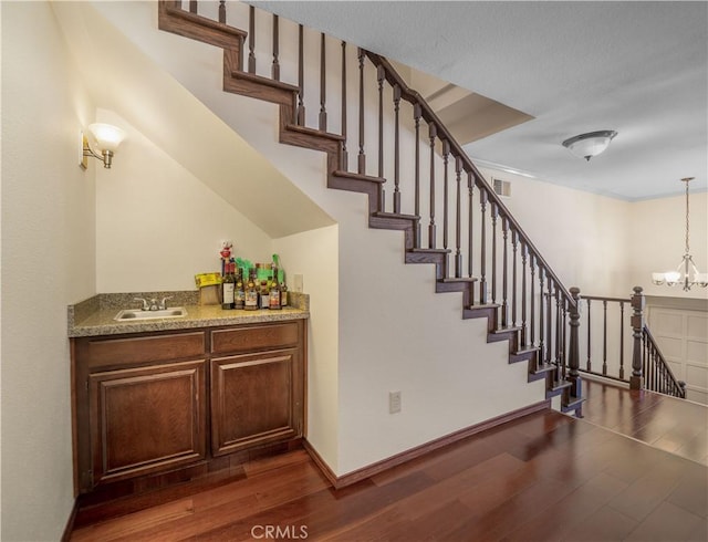 18100 Burbank Blvd Unit 11, Tarzana, CA 91356 - staircase with wood finished floors and a chandelier