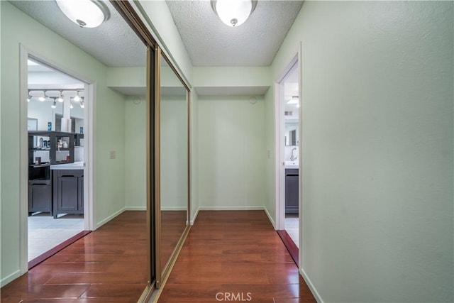 18100 Burbank Blvd Unit 11, Tarzana, CA 91356 - corridor featuring wood finished floors and a textured ceiling