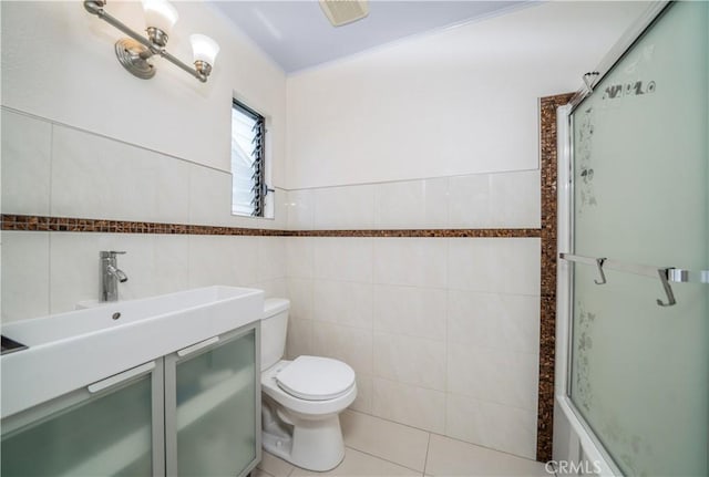 18100 Burbank Blvd Unit 11, Tarzana, CA 91356 - bathroom with tile walls, an enclosed shower, vanity, and tile patterned floors