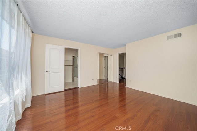 18100 Burbank Blvd Unit 11, Tarzana, CA 91356 - unfurnished room featuring wood finished floors and a textured ceiling