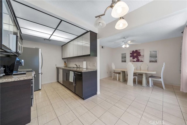 18100 Burbank Blvd Unit 11, Tarzana, CA 91356 - kitchen with ceiling fan, light tile patterned floors, a textured ceiling, and stainless steel microwave