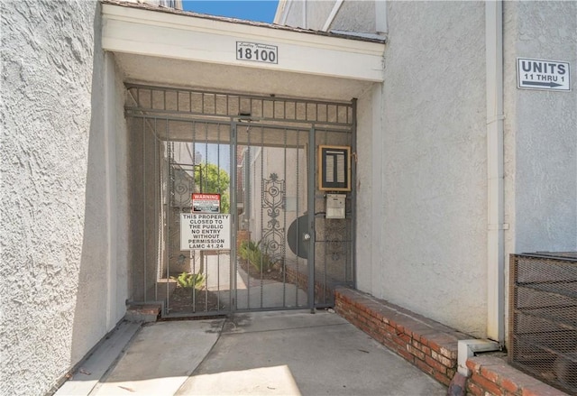 18100 Burbank Blvd Unit 11, Tarzana, CA 91356 - property entrance with stucco siding and a gate