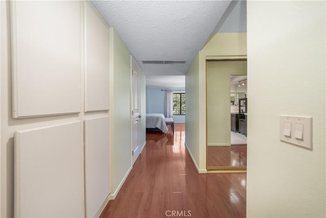18100 Burbank Blvd Unit 11, Tarzana, CA 91356 - hallway featuring wood finished floors and a textured ceiling