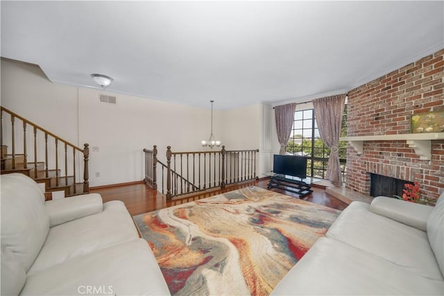 18100 Burbank Blvd Unit 11, Tarzana, CA 91356 - living room featuring a chandelier, wood finished floors, and a fireplace