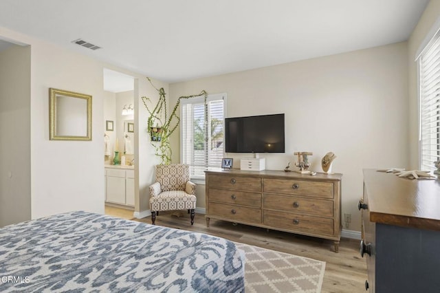 3051 Ketch Pl, Oxnard, CA 93035 - bedroom with multiple windows, wood finished floors, and ensuite bath