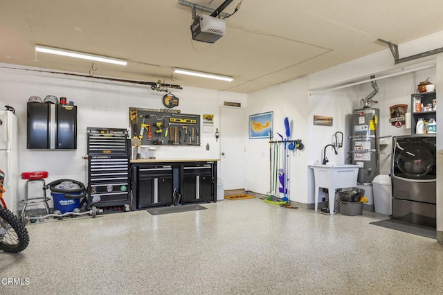 3051 Ketch Pl, Oxnard, CA 93035 - garage featuring water heater, a garage door opener, washer / clothes dryer, and a workshop area