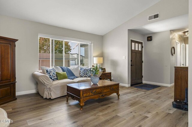 3051 Ketch Pl, Oxnard, CA 93035 - living area featuring lofted ceiling and light wood-style floors