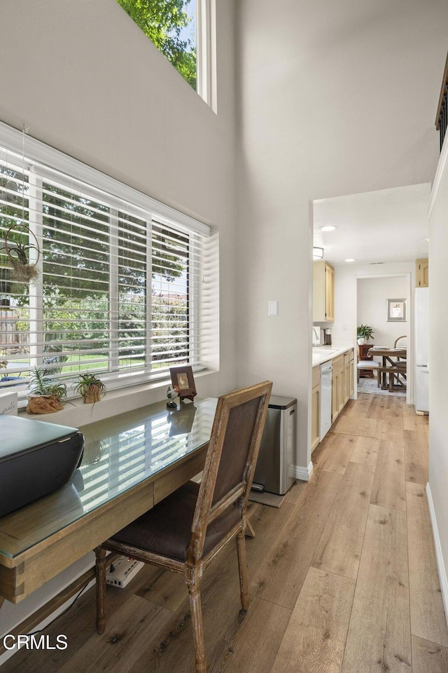 3051 Ketch Pl, Oxnard, CA 93035 - dining area with light wood-style flooring, a towering ceiling, and plenty of natural light