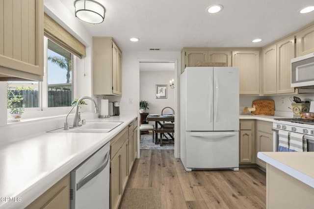 3051 Ketch Pl, Oxnard, CA 93035 - kitchen with white appliances, light countertops, light wood-type flooring, and recessed lighting