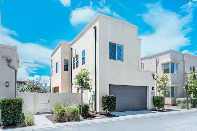 143 Interval, Irvine, CA 92618 - contemporary home featuring stucco siding, an attached garage, and a gate