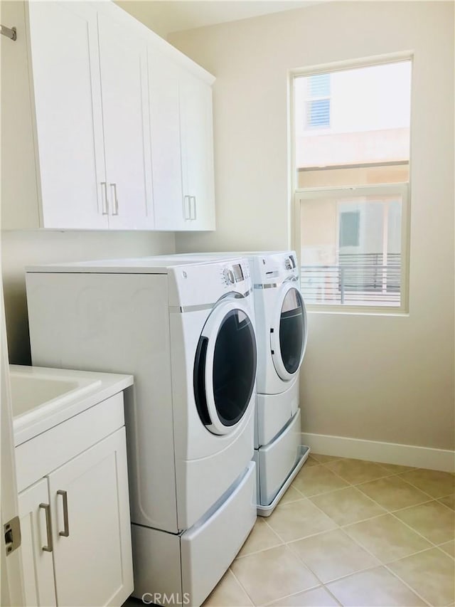 143 Interval, Irvine, CA 92618 - washroom featuring washing machine and dryer, cabinet space, and light tile patterned floors