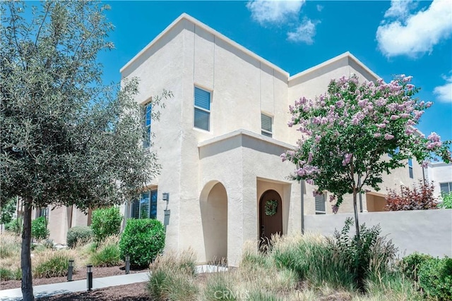 143 Interval, Irvine, CA 92618 - view of front of house with stucco siding and concrete driveway
