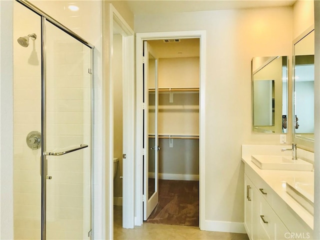 143 Interval, Irvine, CA 92618 - bathroom with a spacious closet, a shower stall, and double vanity
