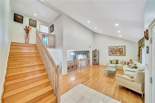 11830 Killimore Ave, Porter Ranch, CA 91326 - living area featuring recessed lighting, wood finished floors, high vaulted ceiling, and stairs