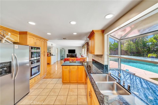 11830 Killimore Ave, Porter Ranch, CA 91326 - kitchen featuring stainless steel appliances, recessed lighting, light tile patterned flooring, a peninsula, and backsplash