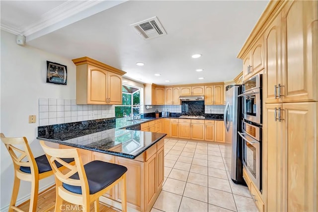 11830 Killimore Ave, Porter Ranch, CA 91326 - kitchen with light brown cabinetry, a peninsula, decorative backsplash, dark stone counters, and a kitchen bar