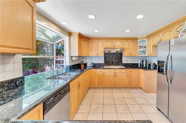 11830 Killimore Ave, Porter Ranch, CA 91326 - kitchen featuring stainless steel appliances, under cabinet range hood, light tile patterned flooring, decorative backsplash, and dark stone counters