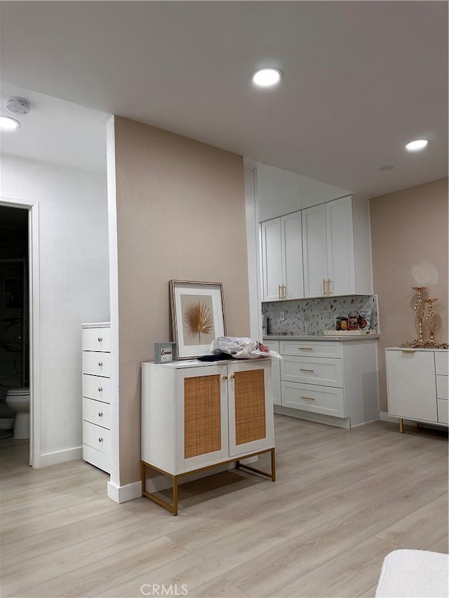 6350 Genesee Ave Unit 107, San Diego, CA 92122 - kitchen featuring light wood-style flooring, backsplash, white cabinetry, recessed lighting, and light countertops