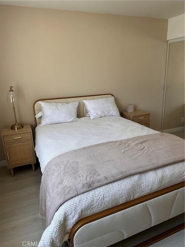 6350 Genesee Ave Unit 107, San Diego, CA 92122 - bedroom featuring baseboards and light wood-type flooring