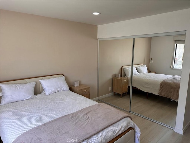 6350 Genesee Ave Unit 107, San Diego, CA 92122 - bedroom with light wood-type flooring, a closet, and recessed lighting