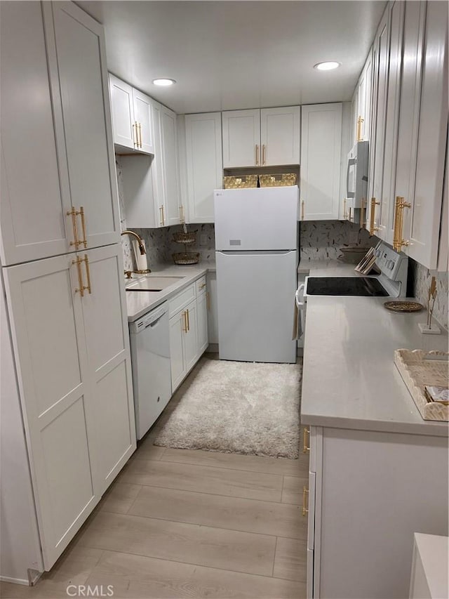 6350 Genesee Ave Unit 107, San Diego, CA 92122 - kitchen featuring white appliances, backsplash, light wood-style floors, white cabinetry, and light countertops