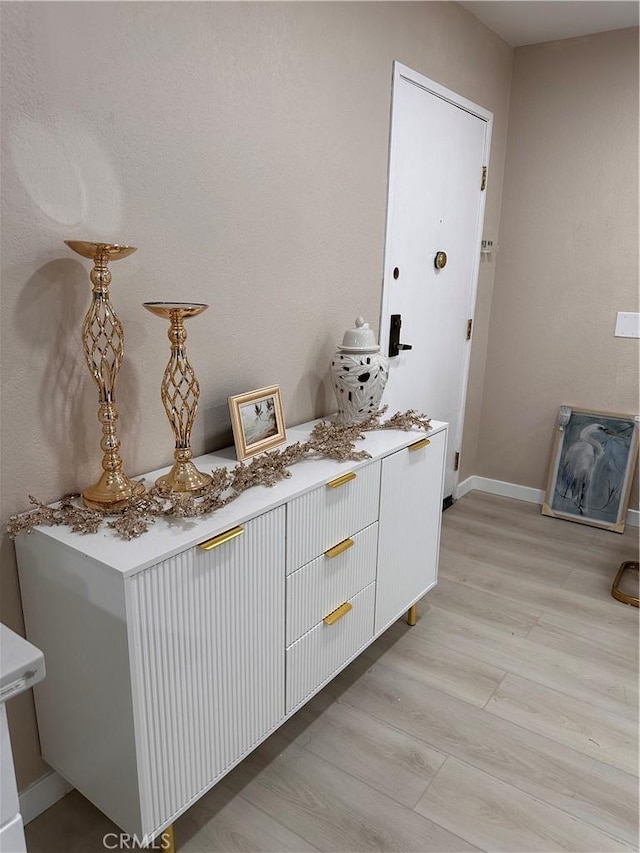 6350 Genesee Ave Unit 107, San Diego, CA 92122 - bar with baseboards and light wood-type flooring