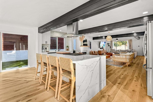 3167 Camarillo Ave, Oceanside, CA 92056 - kitchen with light wood-style floors, stainless steel appliances, white cabinetry, island range hood, and recessed lighting