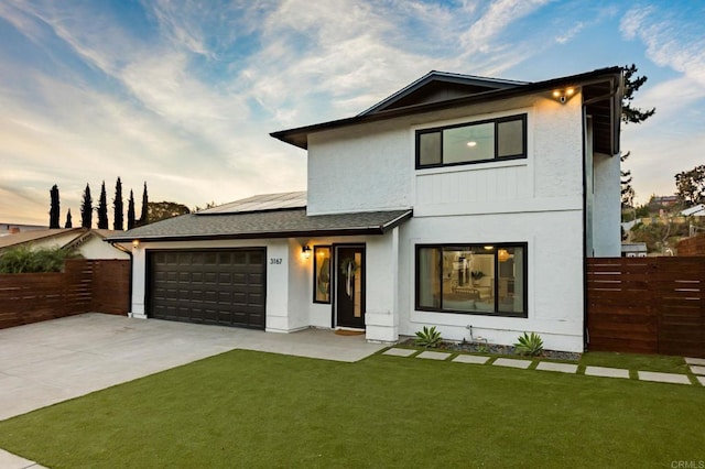 3167 Camarillo Ave, Oceanside, CA 92056 - view of front facade featuring solar panels, an attached garage, driveway, stucco siding, and a shingled roof