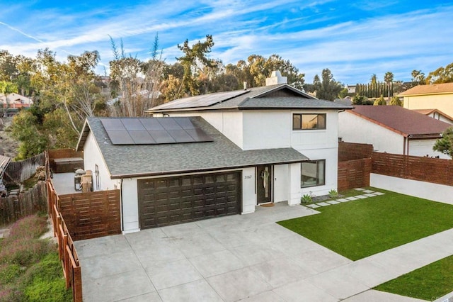 3167 Camarillo Ave, Oceanside, CA 92056 - view of front of house with a shingled roof, roof mounted solar panels, stucco siding, and concrete driveway