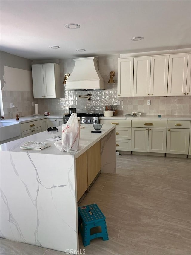 35658 Denali Way, Winchester, CA 92596 - kitchen featuring custom range hood, backsplash, light stone countertops, and stove