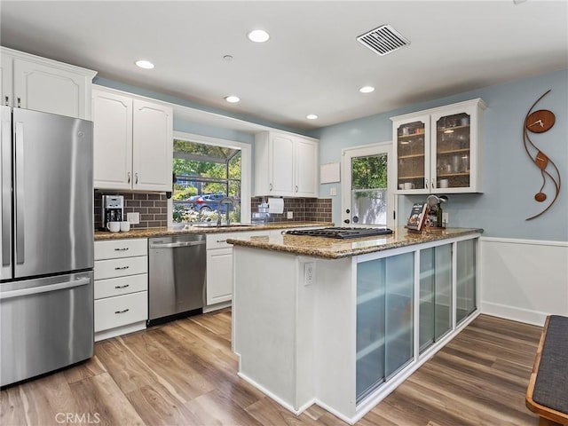 3828 2nd Ave, La Crescenta, CA 91214 - kitchen with stainless steel appliances, plenty of natural light, glass insert cabinets, stone counters, and recessed lighting