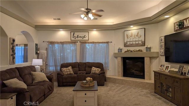 3242 Ashbury Ave, Madera, CA 93637 - carpeted living area with ceiling fan, arched walkways, and a premium fireplace