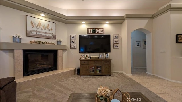 3242 Ashbury Ave, Madera, CA 93637 - tiled living room with arched walkways, a tile fireplace, recessed lighting, and carpet flooring