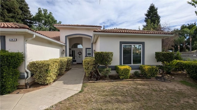 3242 Ashbury Ave, Madera, CA 93637 - view of front of property featuring a tiled roof, stucco siding, and a front lawn