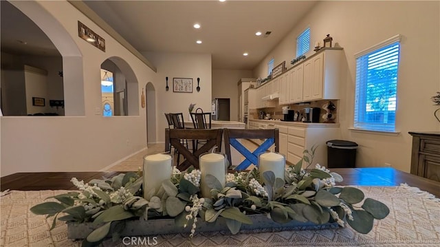 3242 Ashbury Ave, Madera, CA 93637 - kitchen featuring recessed lighting, white cabinets, arched walkways, and under cabinet range hood