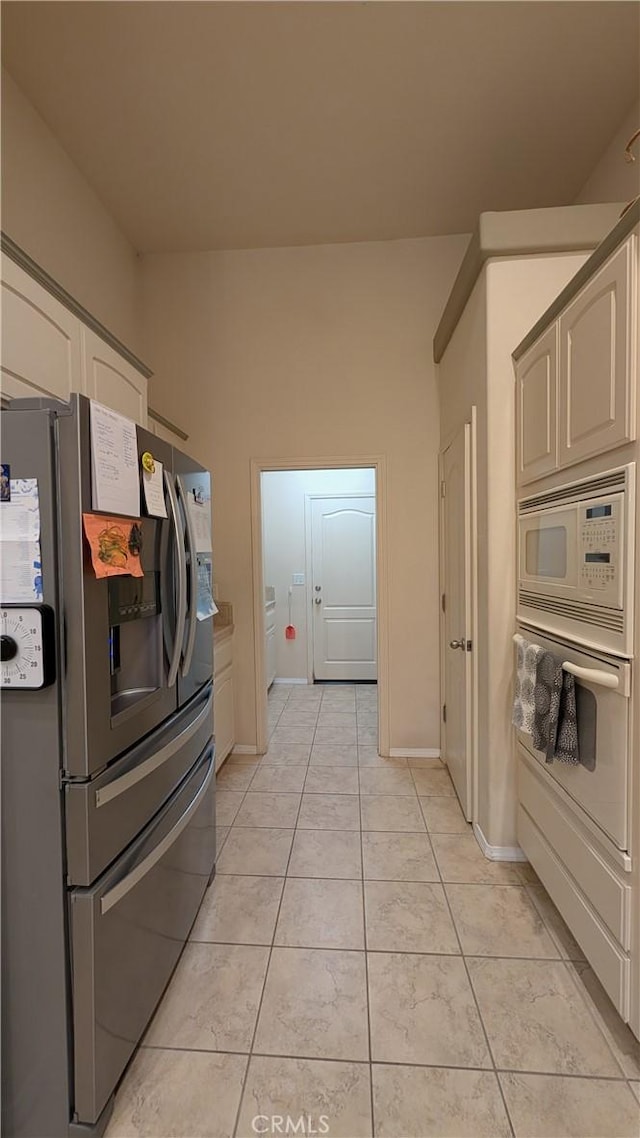 3242 Ashbury Ave, Madera, CA 93637 - kitchen with white appliances and light tile patterned floors