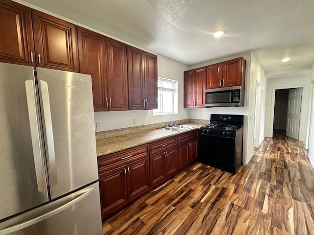 550206 E University Ave, San Diego, CA 92105 - kitchen featuring appliances with stainless steel finishes, dark wood finished floors, light countertops, and dark brown cabinets