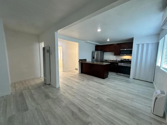550206 E University Ave, San Diego, CA 92105 - kitchen featuring appliances with stainless steel finishes, a heating unit, light wood finished floors, dark brown cabinets, and a kitchen island