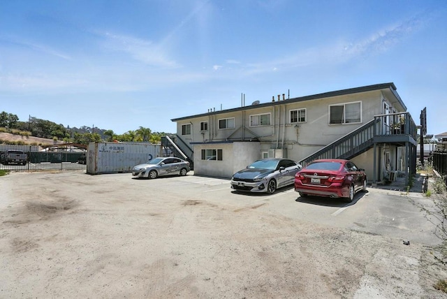 550206 E University Ave, San Diego, CA 92105 - view of property featuring stairs and uncovered parking