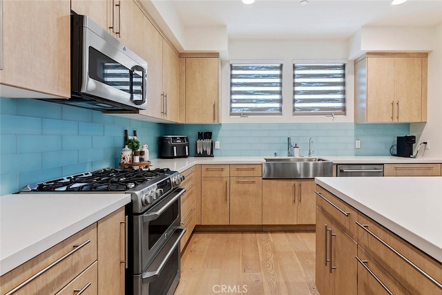 4240 Laurel Canyon Blvd Unit 307, Studio City, CA 91604 - kitchen with appliances with stainless steel finishes, light brown cabinetry, light wood-type flooring, light countertops, and recessed lighting
