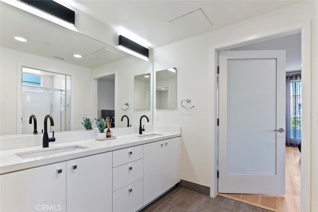 4240 Laurel Canyon Blvd Unit 307, Studio City, CA 91604 - bathroom featuring double vanity, wood finished floors, a shower stall, plenty of natural light, and recessed lighting
