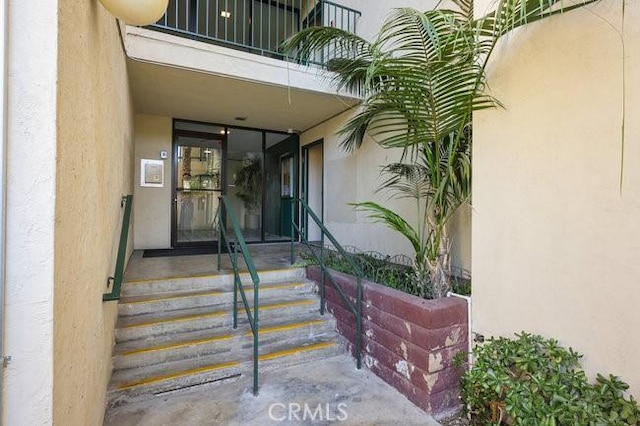5885 El Cajon Blvd Unit 105, San Diego, CA 92115 - view of exterior entry with stucco siding and a balcony